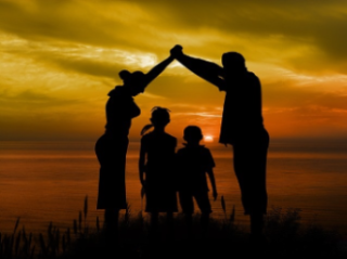 Photo of a family watching the sunset